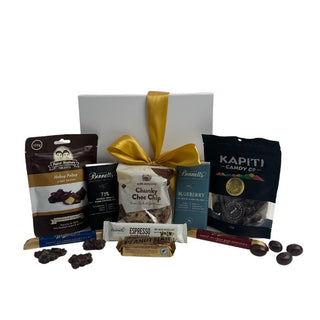 Gift Box Image Medium glossy white gift box with Mrs Higgin's chocolate cookie, chocolate covered almonds, two Whittakers chocolate bars, Whittaker peanut slab, espresso chocolate bar, two bennetts chocolate bars and chocolate covered hokey pokey Batenburgs Gift Baskets Auckland
