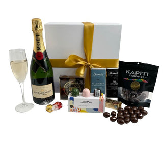 Gift Box Image Large white gift box with Moët and Chandon Imperial Champagne, Chocolate covered almonds, House of Chocolate bonbons three pack, Luxury Devonport Chocolates nine packs, two Bennett's of Mangawhai chocolate bars, cococups with strawberry and two pieces of Lindt chocolate Batenburgs Gift Baskets Auckland