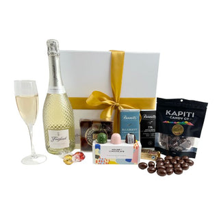 Gift Box Image Large white gift box with Freixenet Prosecco 750ml, Chocolate covered almonds, House of Chocolate bonbons three pack, Luxury Devonport Chocolates nine packs, two Bennett's of Mangawhai chocolate bars, cococups with strawberry and two pieces of Lindt chocolate Batenburgs Gift Baskets Auckland