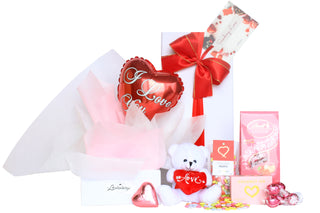 Gift Box Image Medium white rectangle deluxe gift box with red heart shaped I love you balloon, white love themed teddy bear, chocolate hearts, coconut ice and Lindt Lindor chocolate Batenburgs Gift Baskets Auckland 