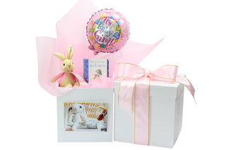 White gift box with pink Vilene, pink it's a girl balloon, Flopsy Bunny soft toy and Peter Rabbit book