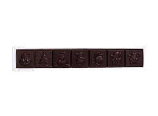 Dark chocolate bar with embossed designs in a white box on a beige background