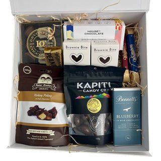 Gift Box Image Large wooden gift box with chocolate covered hokey pokey, two bars of Bennett's of Mangawhai chocolate, Herb and spice brownie bite, House of Chocolate bonbons, Whittakers peanut slab, Chocolate covered almonds, Luxury Devonport chocolate selection and two Whittakers chocolate bars, shot from above, Batenburgs Gift Baskets Auckland