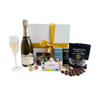 Gift Box Image Large white gift box with Cloudy Bay Pelorus Sparkling Brut 750ml, Chocolate covered almonds, House of Chocolate bonbons three pack, Luxury Devonport Chocolates nine packs, two Bennett's of Mangawhai chocolate bars, cococups with strawberry and two pieces of Lindt chocolate Batenburgs Gift Baskets Auckland