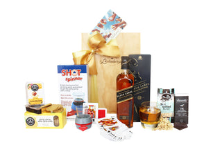 Gift Box Image Large wooden gift box with 750ml Johnnie Walker Black Label, shot spinner, Rutherford and Meyer fruit paste and crackers, sea salted peanuts, playing cards and Bennett's of Mangawhai dark chocolate bar 60 grams. Batenburgs Gift Baskets Auckland 