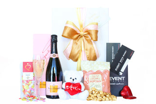  Gift Box Image Large white deluxe gift box with Veuve Clicquot rosé, caramel popcorn, movie tickets, chocolate hearts and a love teddy bear Batenburgs Gift Baskets Auckland 