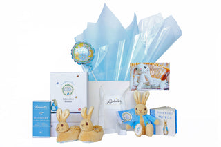 Gift Box Image Gift bag with blue Vilene Peter Rabbit themed gift hamper with soft toy, baby boots, baby book and chocolate. Gift Baskets Auckland Batenburgs Gift Baskets Auckland 