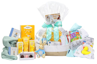 Gift basket featuring baby products such as Weleda body lotion, shampoo and body wash and nappy change cream, Peter Rabbit soft toy, rubber duckie, baby blankets, two Peter Rabbit books and house of Chocolate three pack of bon bons
