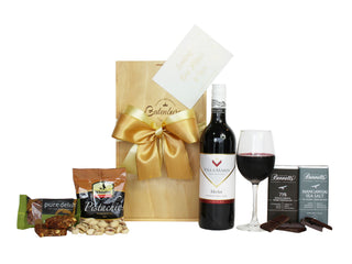 Medium wooden gift box, pure delish nut bar, pistachio nuts, Villa Maria Merlot wine 750ml and two Bennett's of Mangawhai chocolate bars 60 grams each