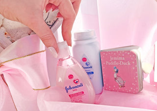New baby girl white gift box with Johnson's baby lotion and baby powder and a little Jemima Puddle Duck story book. Delivered NZ wide by Batenburgs Gift Hampers