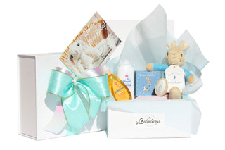 New baby boy celebration gift with a white gift box with Johnson and Johnson baby products, Peter Rabbit book and Peter Rabbit soft toy.