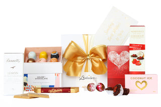 Gift Box Image White gift box with House of Chocolates bonbon three packs, Bennett's of Mangawhai chocolate bar, Whittaker's chocolate bar 25g, two individual Lindt Lindor chocolate bites, shortbread, cococup with strawberry and coconut ice Batenburgs Gift Baskets Auckland 