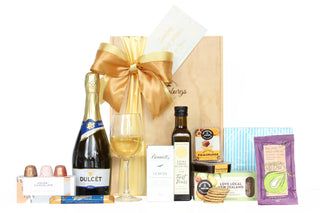 Gift Box Image with Dulcet sparkling wine 750ml, Whittaker's chocolate 25g, House of Chocolate bonbons three pack, Bennett's of Mangawhai chocolate bar, Extra virgin olive oil 250ml, fruit paste, crackers, gourmet dip mix sachet and napkins