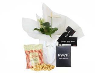 Flowers in white gift bag with caramel popcorn and Event Cinemas movie tickets